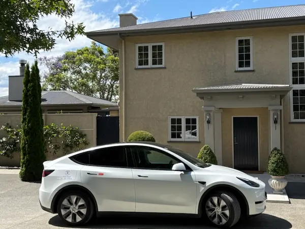 Fully electric Tesla Model Y outside a Hawke's Bay country house