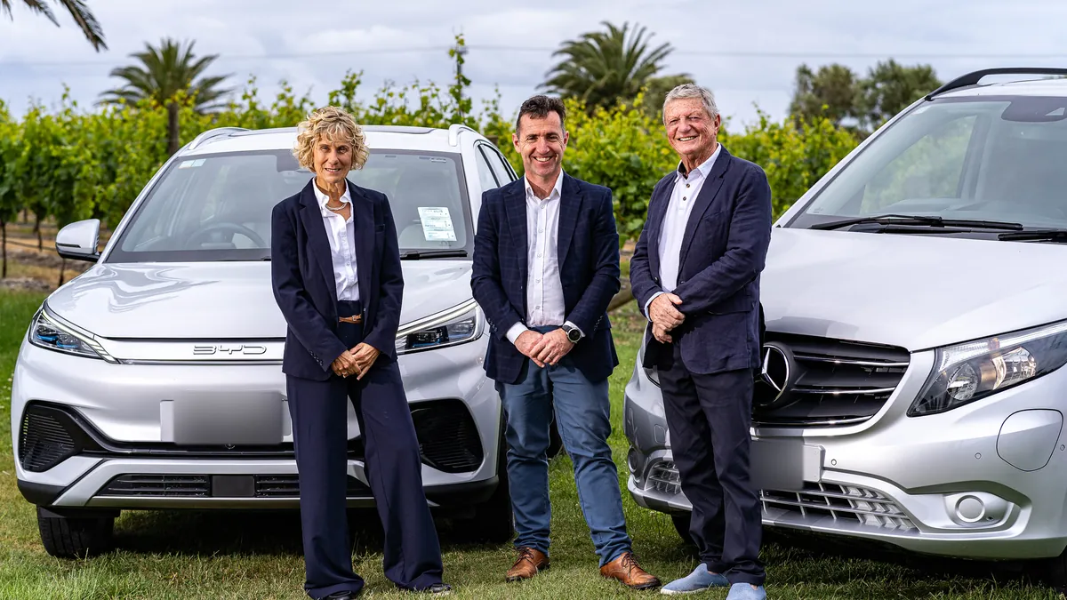 Three Electric Executive hosts standing between the BYD Atto 3 and Mercedes-Benz eVito in a Hawke's Bay vineyard